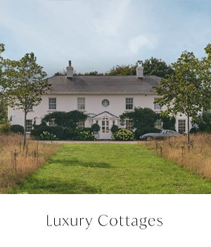 Luxury Cottages - Luxury white farmhouse with open fields in front of it