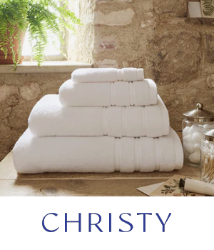 Christy Towels - White towels stacked on a countertop in cottage