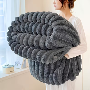 Woman holding a chunky grey blanket