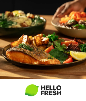 HelloFresh - Plate of salmon and vegetables garnished with herbs and a lemon slice