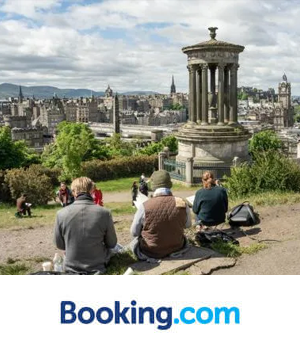 Booking.com - Group of people sitting on a hill overlooking Edinburgh