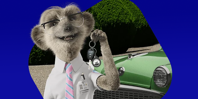 Compare the Market Car Insurance - Sergei the meerkat holding car keys in front of a vehicle