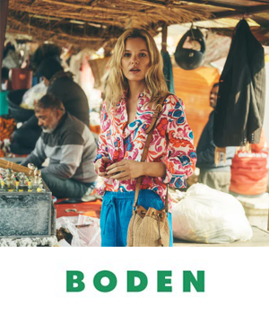 Boden - Woman in market wearing vibrant pink shirt