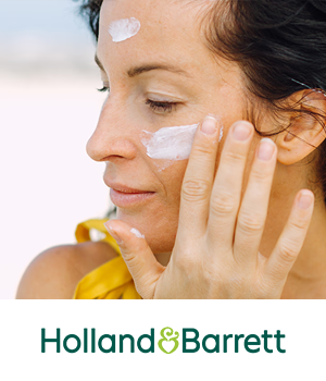 Holland & Barrett - Woman applying sunscreen to face