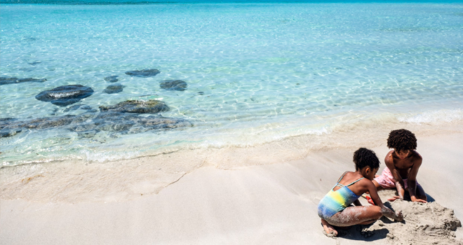 TUI - Children making a sandcastle by the sea