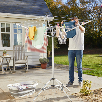 Lakeland - Man hanging clothes on a rotary outdoor airer
