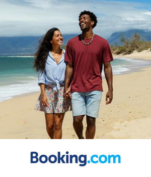 Booking.com - Couple walking up the beach
