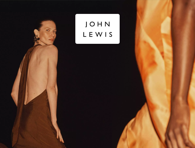 John Lewis - A woman in a backless brown dress looks over her shoulder against a black background