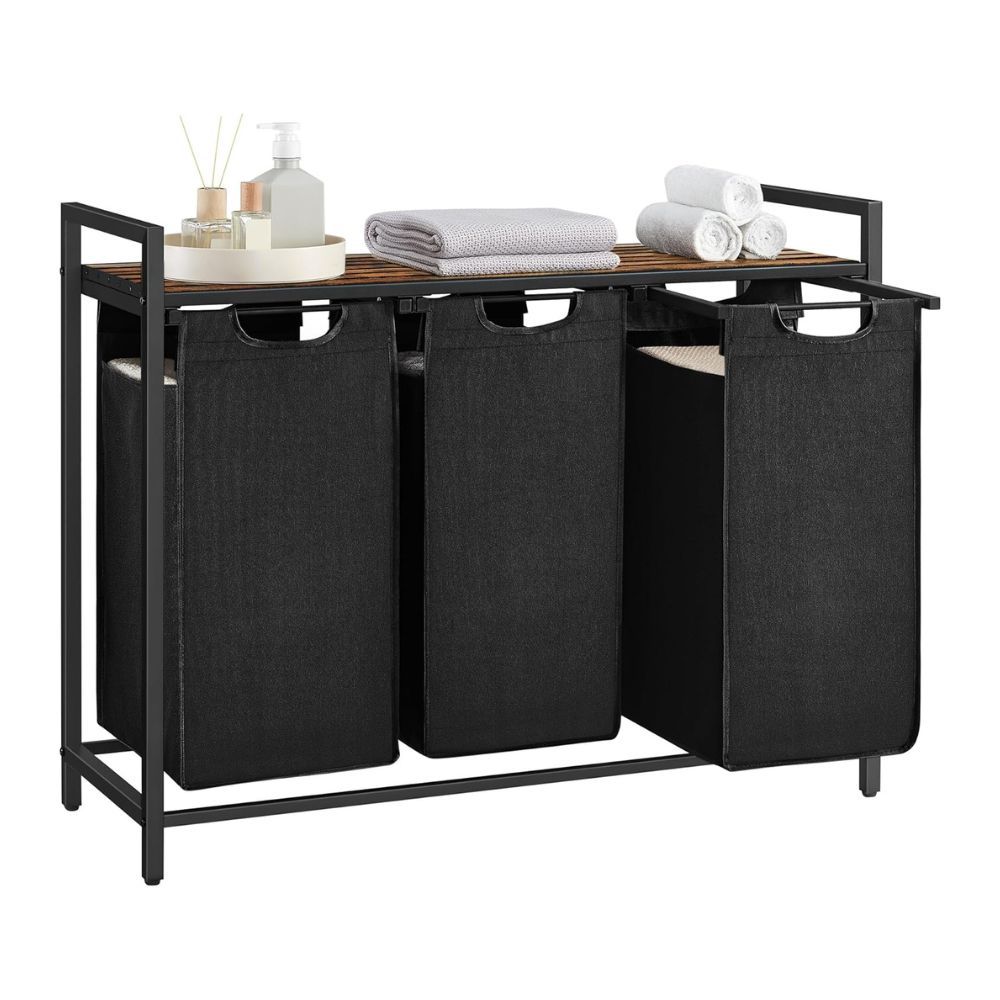 a storage unit with three baskets and a table with towels