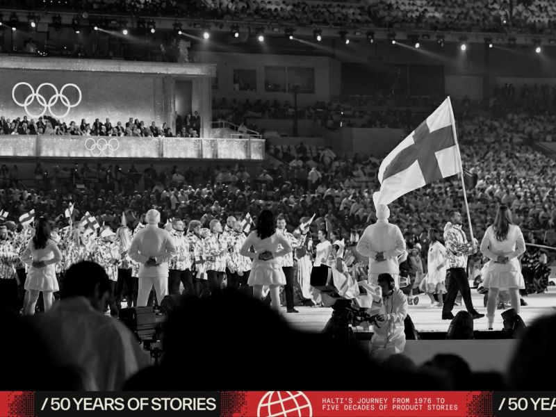 an image of a crowd of people standing on a stage with a flag