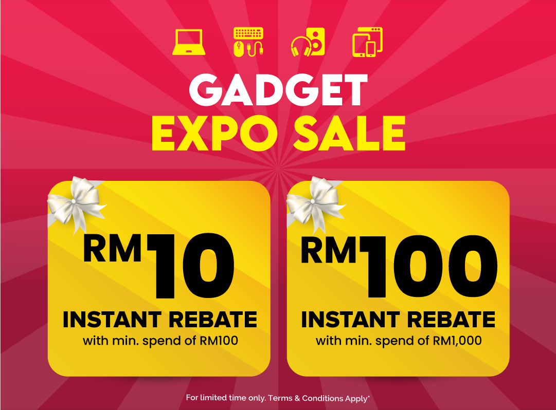 Man in a gray blazer over a dark gray shirt standing on stairs in an urban background.