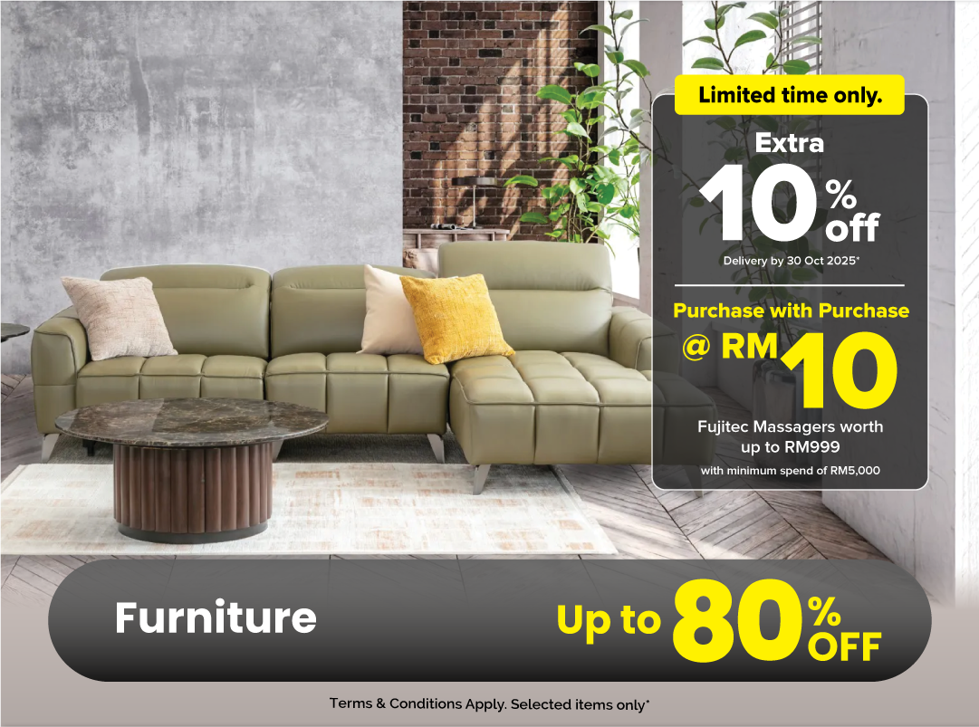 Woman wearing an olive green blazer and light blue jeans walking in an urban setting.