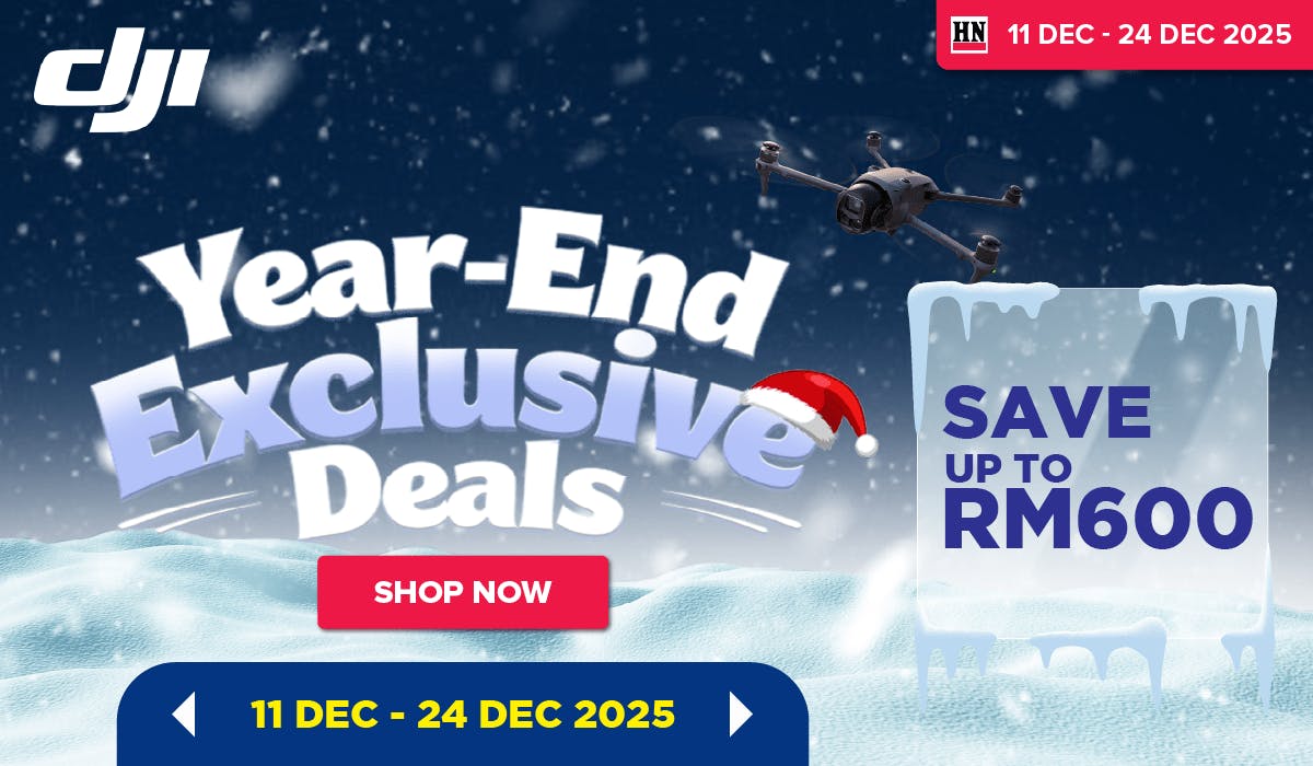 Woman wearing an olive green blazer and light blue jeans walking in an urban setting.