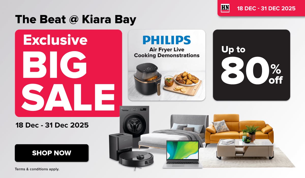 Woman wearing an olive green blazer and light blue jeans walking in an urban setting.