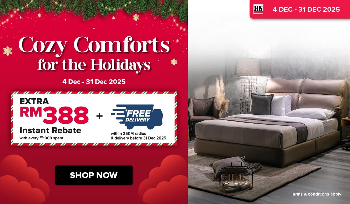 Woman wearing an olive green blazer and light blue jeans walking in an urban setting.