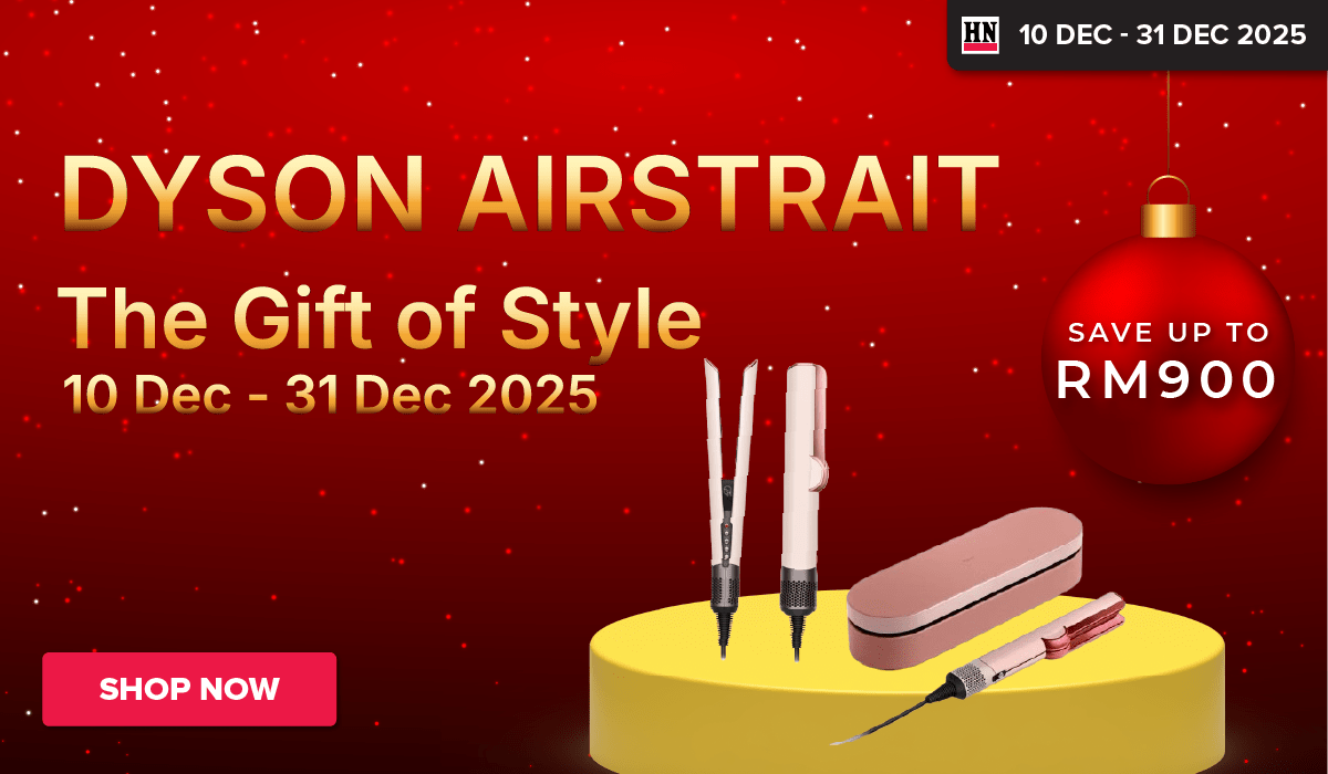 Woman wearing an olive green blazer and light blue jeans walking in an urban setting.