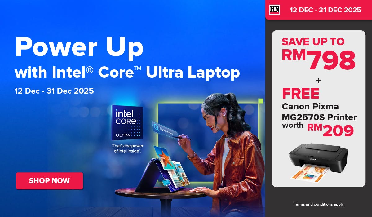 Man in a gray blazer over a dark gray shirt standing on stairs in an urban background.