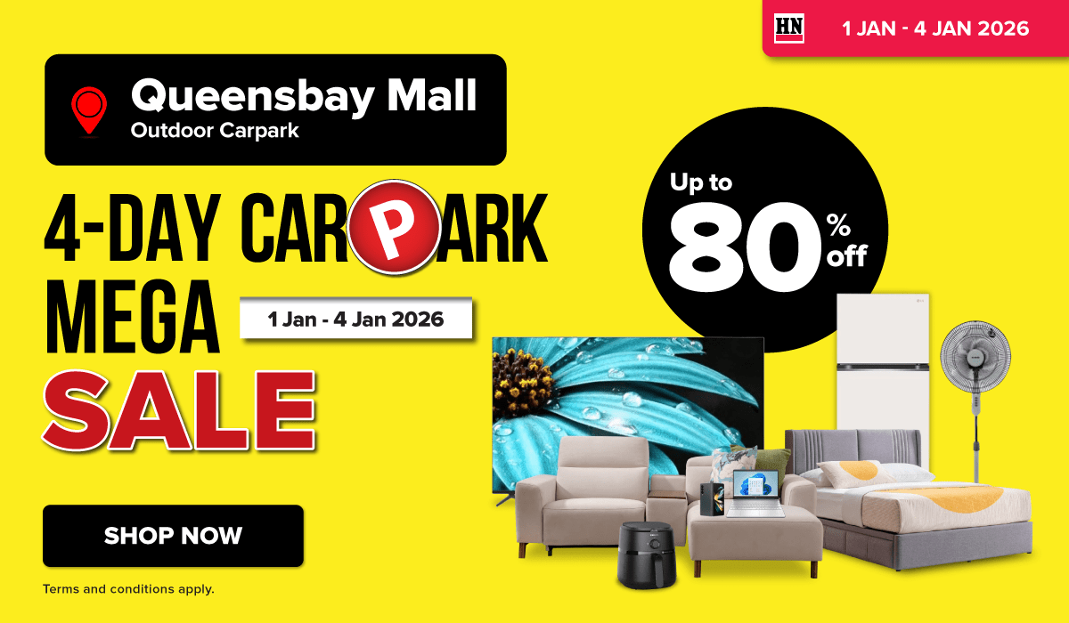 Woman wearing an olive green blazer and light blue jeans walking in an urban setting.