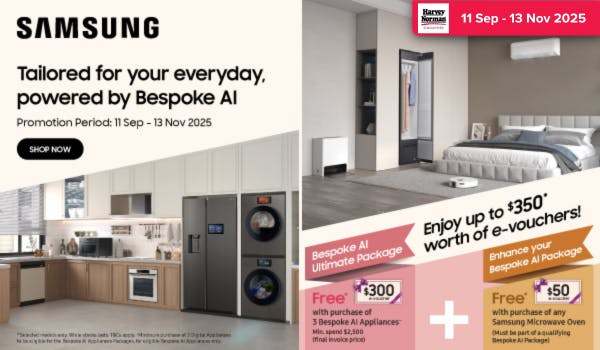 Man in a gray blazer over a dark gray shirt standing on stairs in an urban background.