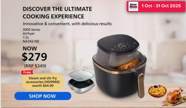 Man in a gray blazer over a dark gray shirt standing on stairs in an urban background.