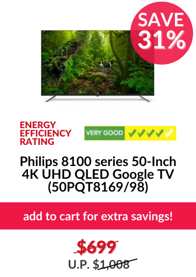 Man in a gray blazer over a dark gray shirt standing on stairs in an urban background.