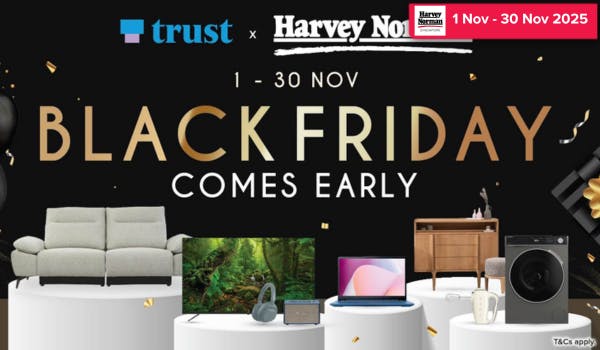 Man in a gray blazer over a dark gray shirt standing on stairs in an urban background.