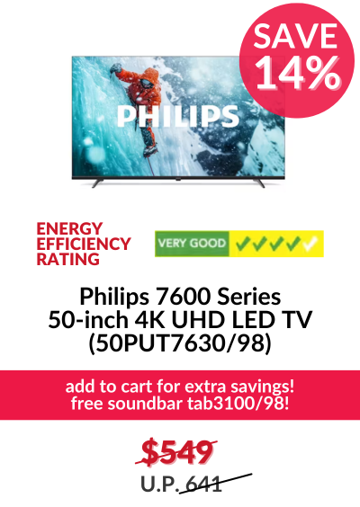 Man in a gray blazer over a dark gray shirt standing on stairs in an urban background.