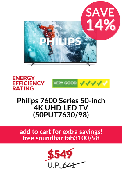 Man in a gray blazer over a dark gray shirt standing on stairs in an urban background.