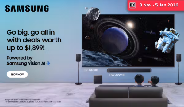 Woman wearing an olive green blazer and light blue jeans walking in an urban setting.