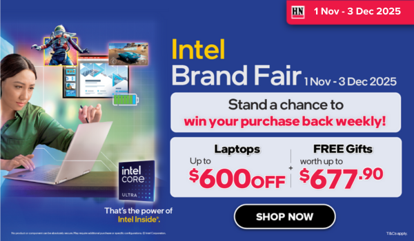 Woman wearing an olive green blazer and light blue jeans walking in an urban setting.