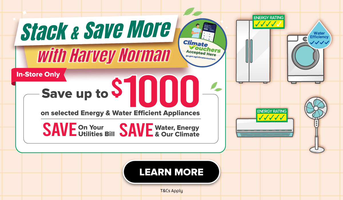 Man in a gray blazer over a dark gray shirt standing on stairs in an urban background.