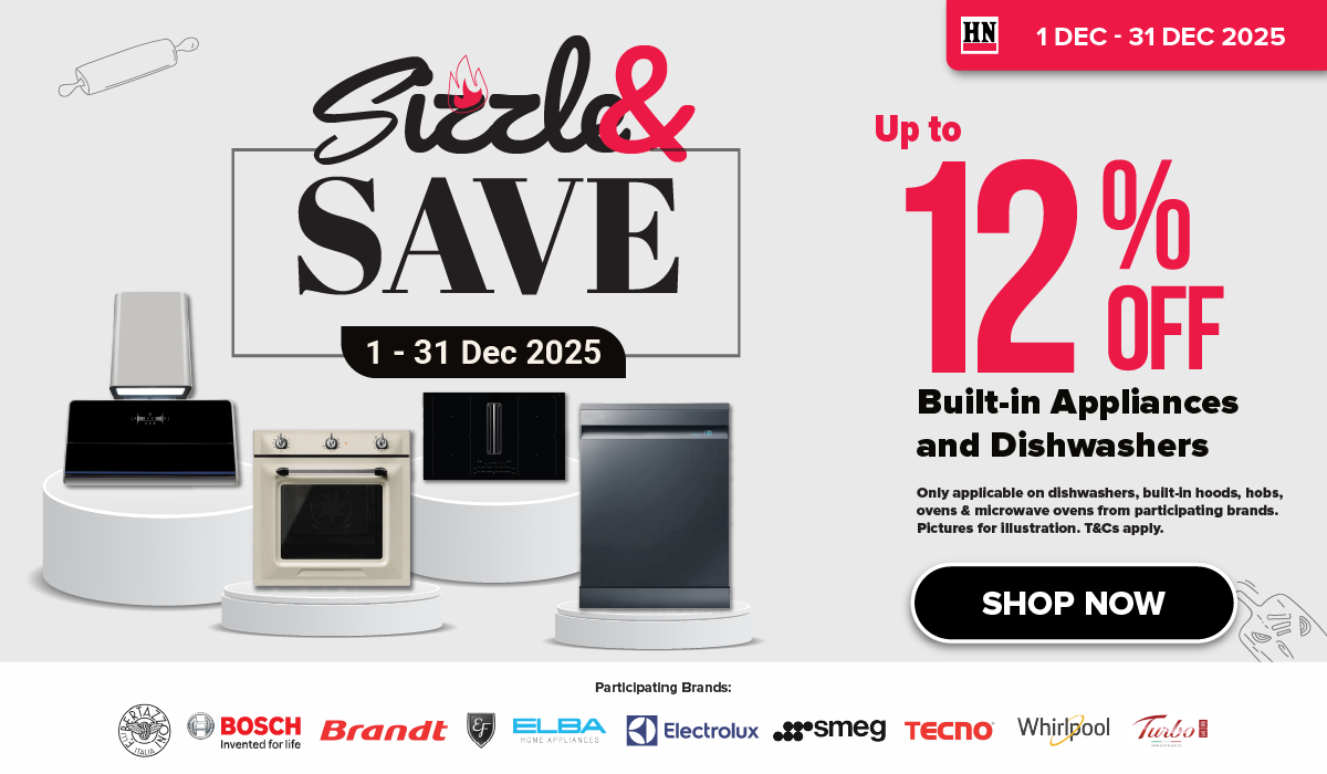 Woman wearing an olive green blazer and light blue jeans walking in an urban setting.