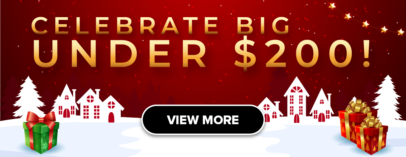 Man in a gray blazer over a dark gray shirt standing on stairs in an urban background.