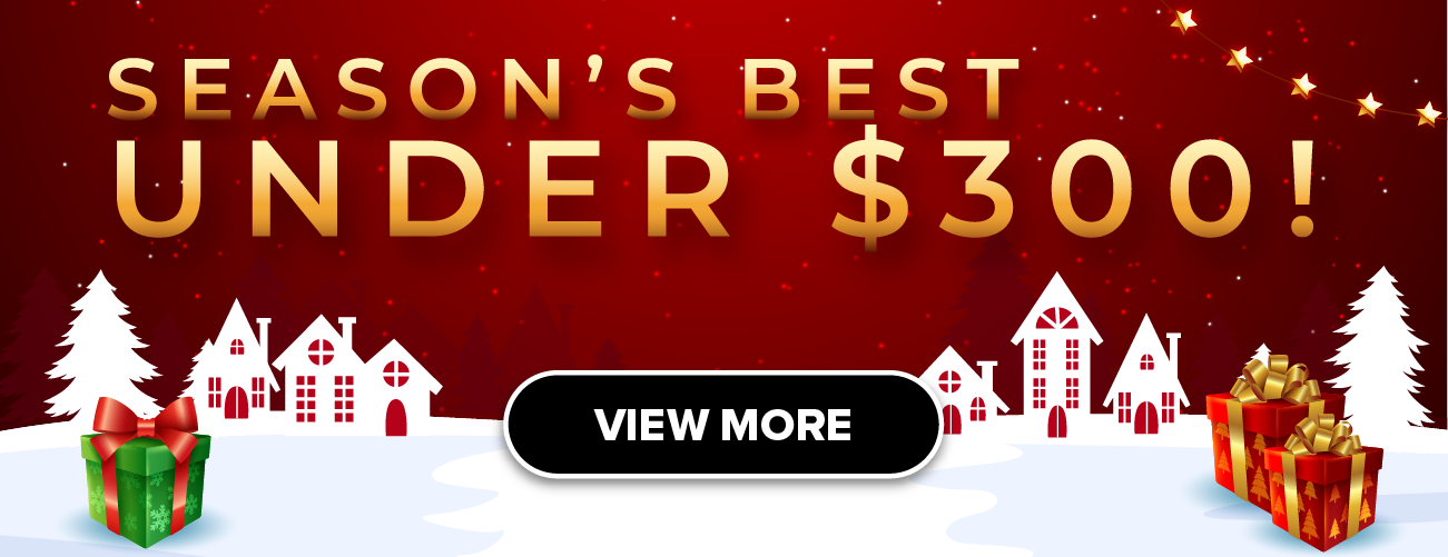 Woman wearing an olive green blazer and light blue jeans walking in an urban setting.