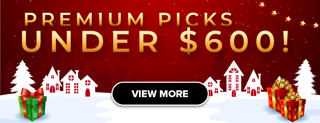 Man in a gray blazer over a dark gray shirt standing on stairs in an urban background.