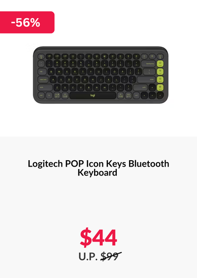 Woman wearing an olive green blazer and light blue jeans walking in an urban setting.