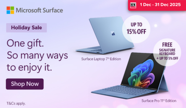 Woman wearing an olive green blazer and light blue jeans walking in an urban setting.