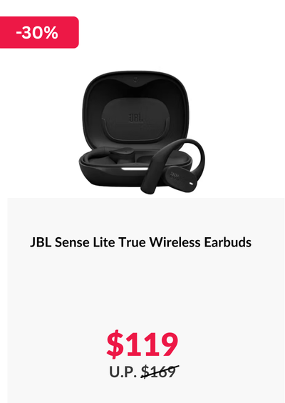 Woman wearing an olive green blazer and light blue jeans walking in an urban setting.