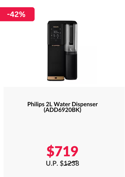 Woman wearing an olive green blazer and light blue jeans walking in an urban setting.