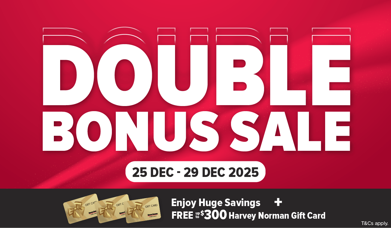 Three women enjoying a shopping day, carrying multiple colorful shopping bags while walking together outdoors.