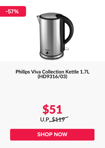 Woman wearing an olive green blazer and light blue jeans walking in an urban setting.