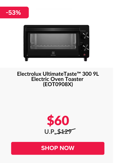 Man in a gray blazer over a dark gray shirt standing on stairs in an urban background.