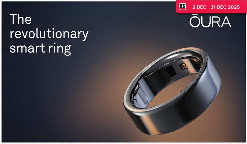 Woman wearing an olive green blazer and light blue jeans walking in an urban setting.