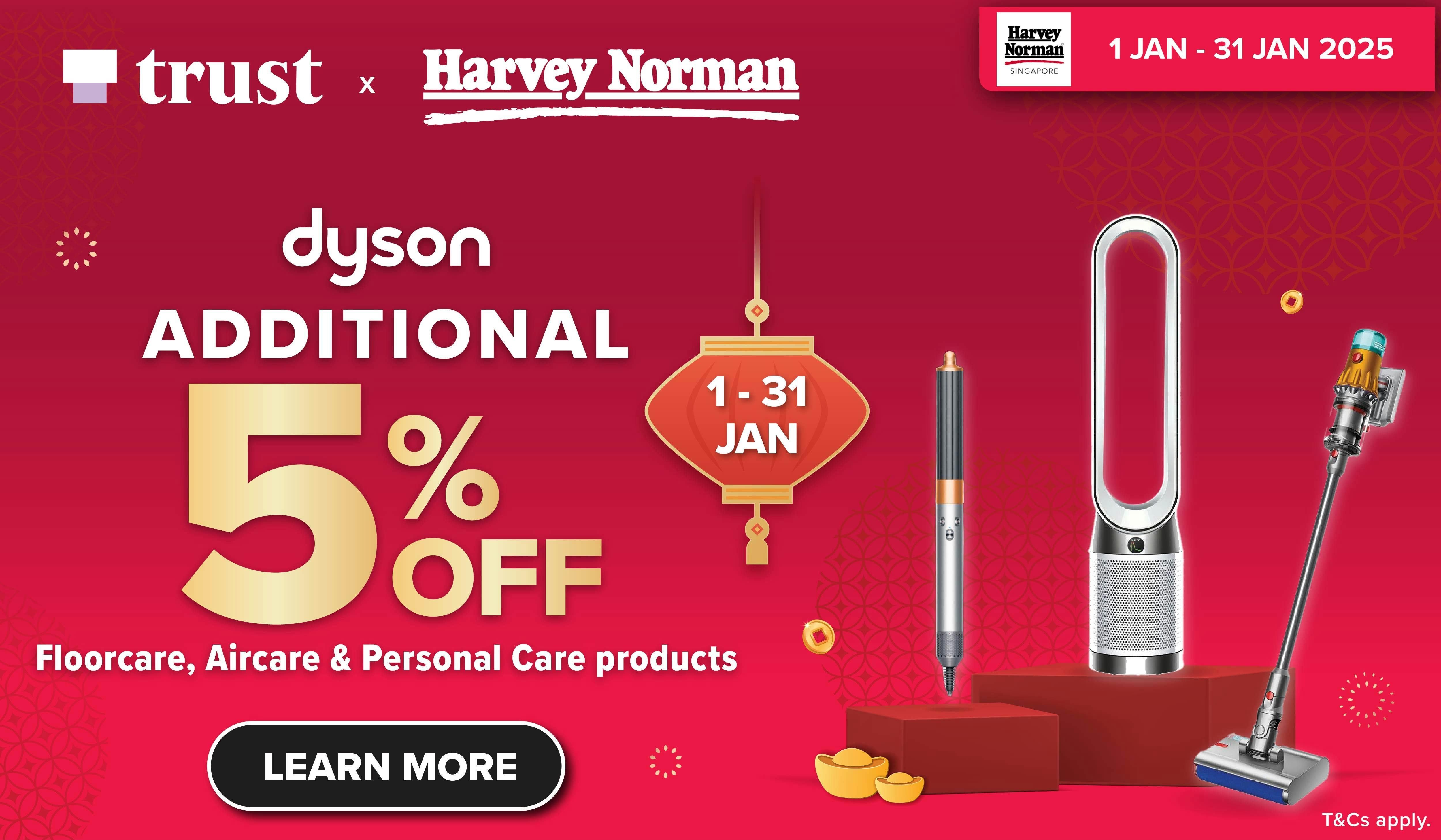 Woman wearing an olive green blazer and light blue jeans walking in an urban setting.