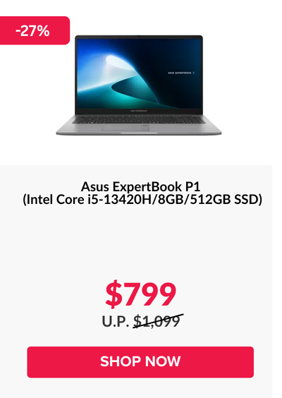 Man in a gray blazer over a dark gray shirt standing on stairs in an urban background.