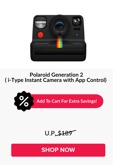 Man in a gray blazer over a dark gray shirt standing on stairs in an urban background.