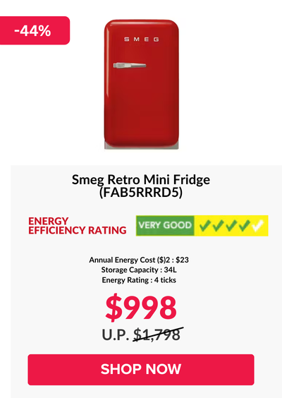 Woman wearing an olive green blazer and light blue jeans walking in an urban setting.