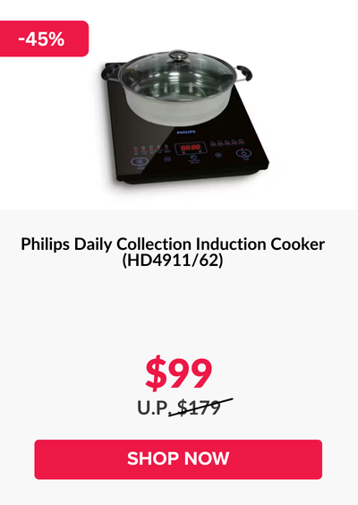 Woman wearing an olive green blazer and light blue jeans walking in an urban setting.