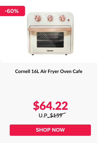 Man in a gray blazer over a dark gray shirt standing on stairs in an urban background.