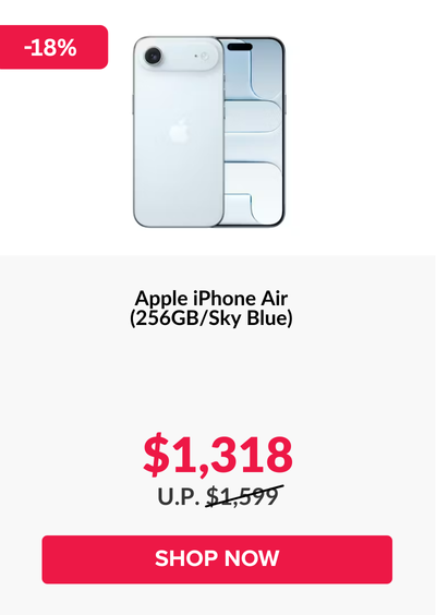 Woman wearing an olive green blazer and light blue jeans walking in an urban setting.